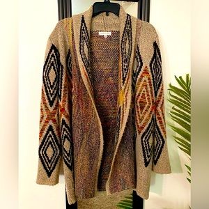 Woven Heart, large cardigan sweater. No pockets, thick, warm, mid thigh length.